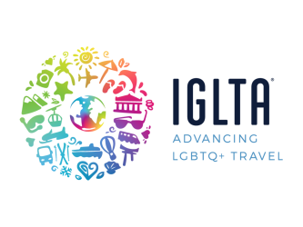 A white background with black text "IGLTA", below that company name in blue text it reads "advancing LGBTQ+ travel". There is a rainbow colored image of a globe surrounded by similarly colored items and places associated with global travel.